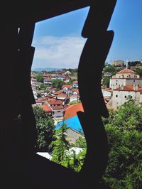 High angle view of townscape against sky seen through window