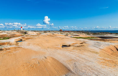 Scenic view of beach against blue sky