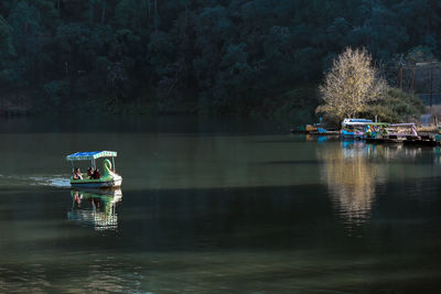 Scenic view of lake with trees in background