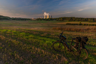 Bicycle on field against sky