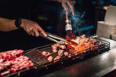 Man preparing food on barbecue grill