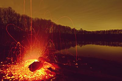 Close-up of fire against sky at night