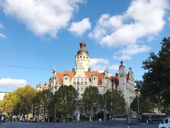 Panoramic view of buildings against cloudy sky