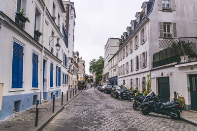 Street amidst buildings in city against sky