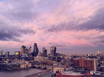 View of cityscape against cloudy sky