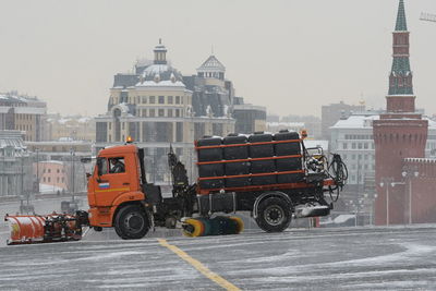 Vehicles on road against buildings in city