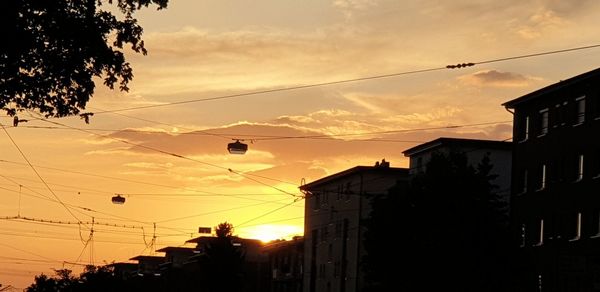 Low angle view of silhouette buildings against sky during sunset