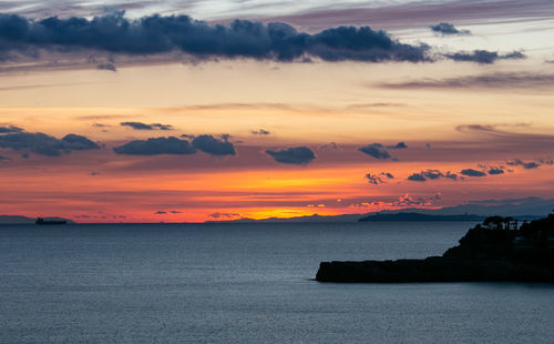 Scenic view of sea against romantic sky at sunset