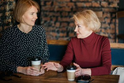 Young woman sitting with coffee