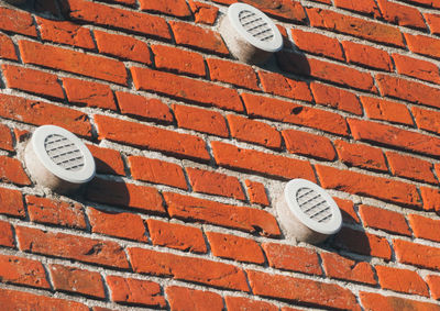 Air ducts on brick wall