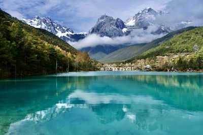 Scenic view of lake and mountains against sky