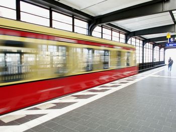 Blurred motion of train at railroad station