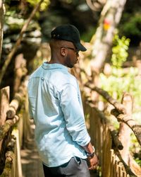 Side view young man standing on footbridge