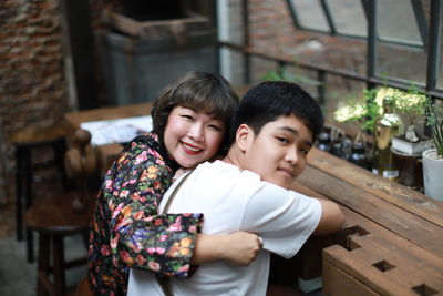 Happy moment mom and boy in coffee cafe.