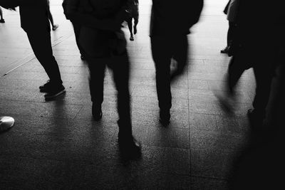 Low section of people walking on street