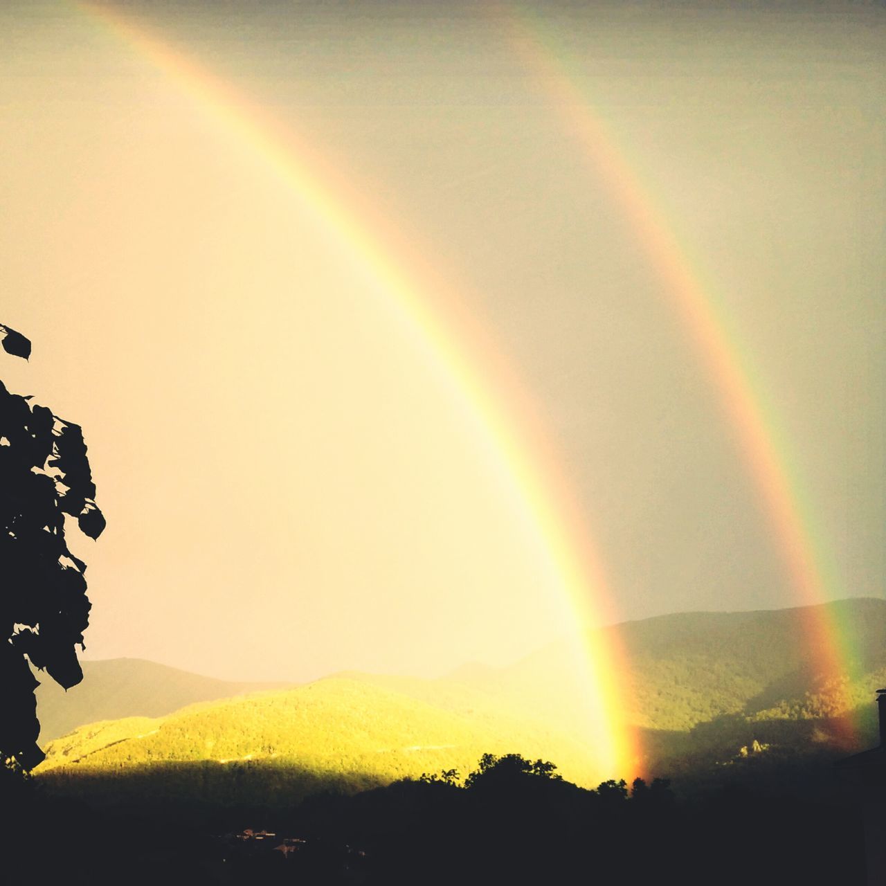 SCENIC VIEW OF RAINBOW OVER MOUNTAIN