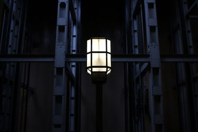 Low angle view of illuminated lamp at night