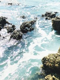 High angle view of rocks in sea