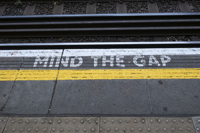 High angle view of text on railroad station platform