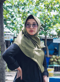 Portrait of young woman standing outdoors