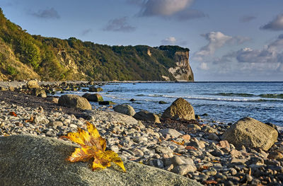 Rocks on beach against sky