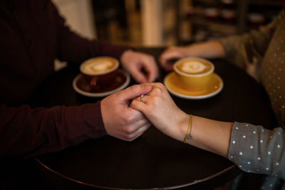 Close-up of hand holding tea cup