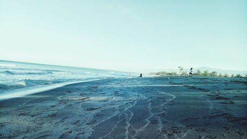 Scenic view of beach against clear sky