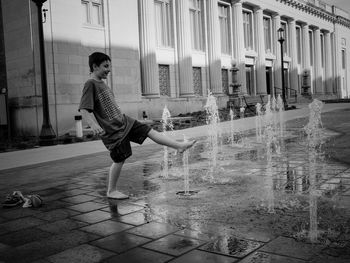 Boy standing against nebraska state capitol building 