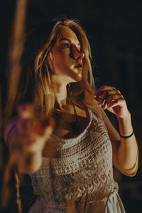 Young woman with arms raised standing in hair