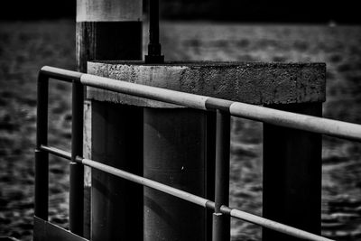 Close-up of railing against water