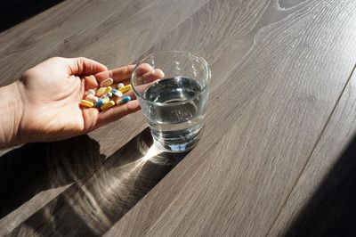 Hand holding glass of water