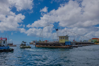 Sailboats in sea against sky