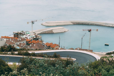 High angle view of sea by buildings against sky