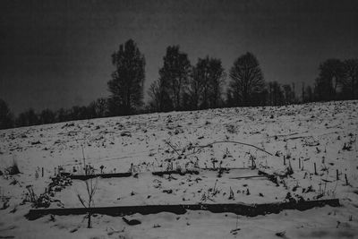 Scenic view of snow covered field against sky