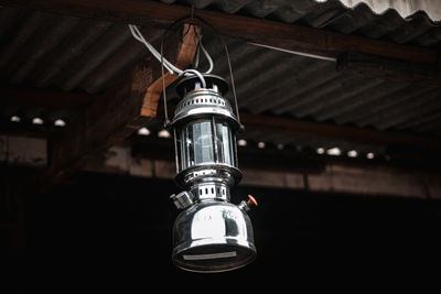 Low angle view of electric lamp hanging from ceiling