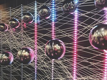 Low angle view of illuminated chandelier hanging on ceiling