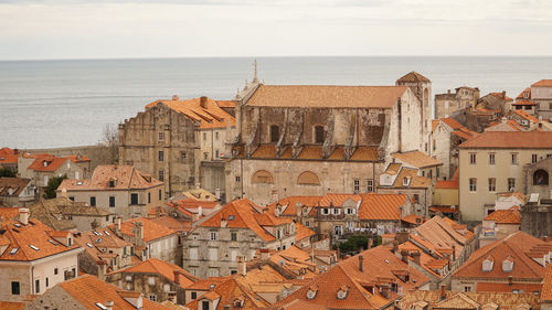 High angle view of townscape by sea against sky