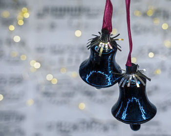 Close-up of illuminated lighting equipment hanging on water