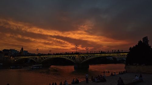 Bridge over river against sky during sunset