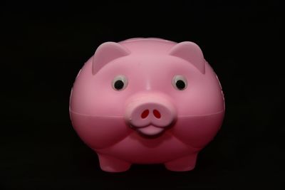 Close-up of pink balloon against black background