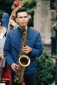 Mid adult man playing guitar