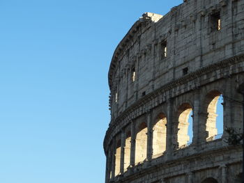 Low angle view of historical building against clear blue sky