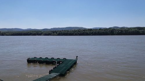 Scenic view of calm lake against clear sky