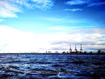 Sailboats in sea against sky