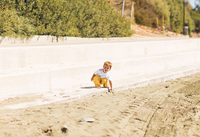 Full length of boy playing on field