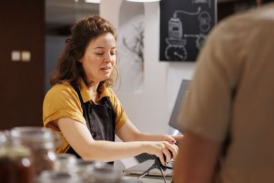 Portrait of young woman using mobile phone