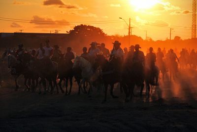 Group of people against sky during sunset