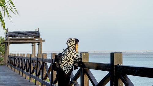 A woman looking to the sea against clear sky