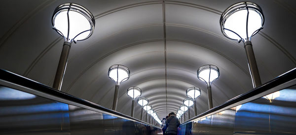 Low angle view of illuminated lights on ceiling