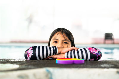 Portrait of young woman sitting on table